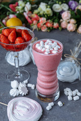 Raspberry smoothie with colored marshmallows and berries. Summer refreshing berry smoothie. smoothie with marshmallows and caramel sweets