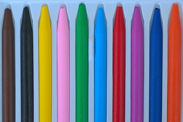 Macro details of lined up colorful wax crayons