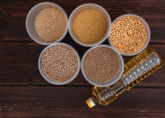 Various cereals and a bottle of sunflower oil. Raw porridge, food supplies in the kitchen.