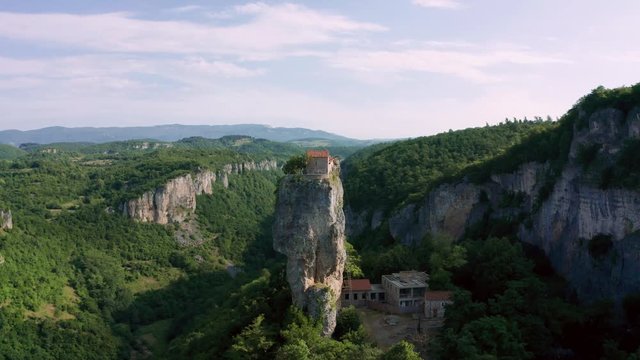 Katskhi pillar. Alone man's monastery near the village of Katskhi. The orthodox church and the abbot cell on a rocky cliff. Imereti, Georgia.