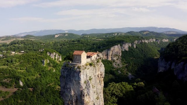 Katskhi pillar. Alone man's monastery near the village of Katskhi. The orthodox church and the abbot cell on a rocky cliff. Imereti, Georgia.