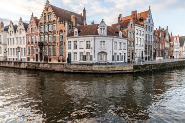 Fototapeta na wymiar Buildings around channels in Bruges at sunset
