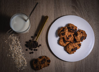Oat chocolate cookies shot from above over a wooden table