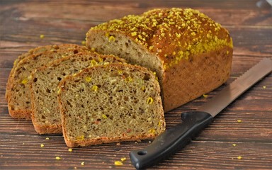 knife and bread baked with seeds and corn