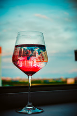 glass of red wine on blue background