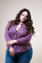 Sexy plus size model in casual clothes, fat woman on beige background