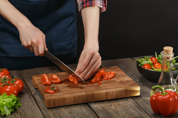 Woman cooking fresh vegetable salad. Female hands. Diet concept for healthy lifestyle with copyspace.