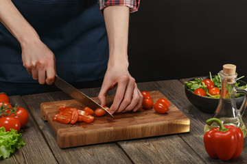 Woman cooking fresh vegetable salad. Female hands. Diet concept for healthy lifestyle with copyspace.