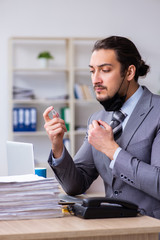 Young male employee in self-quarantine concept