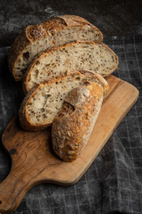 Bread fresh home baking on a wooden board. Black background