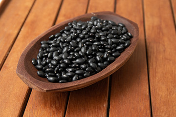 Pile of raw Brazilian Black Beans in a bowl. Also know as 'Feijao'