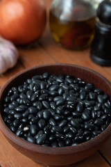 Pile of raw Brazilian Black Beans in a bowl. Also know as 'Feijao'