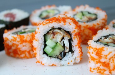 California roll sushi with smoked eel, cucumber, avocado, red caviar. Sushi menu. Japanese food. Close-up