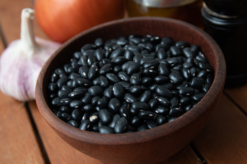 Pile of raw Brazilian Black Beans in a bowl. Also know as 'Feijao'