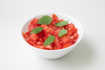 Chopped or Diced Tomatoes in a bowl with basil