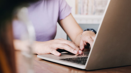 close up young woman type on laptop computer for calculate business data, accountancy document and calculator at office.