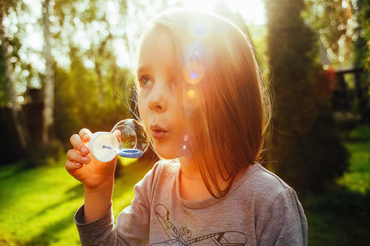 Girl blow bubbles, expectation of summer outdoor recreation, quarantine holiday