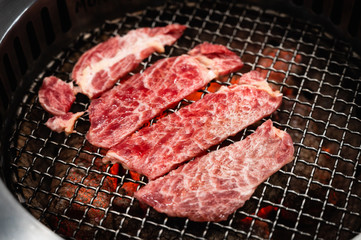 Sliced beef on a grill stove