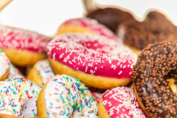 Delicious dessert of donuts. Sweet donuts with different in sweet colored glaze and decorations. Closeup.