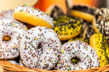Delicious dessert of donuts. Sweet donuts with different in sweet colored glaze and decorations. Closeup.