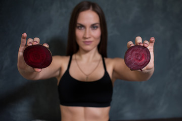 The girl holds the beet halves. Beetroot close-up. Healthy lifestyle.