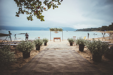 wedding ceremony ambient on the beach with a mountain on the background