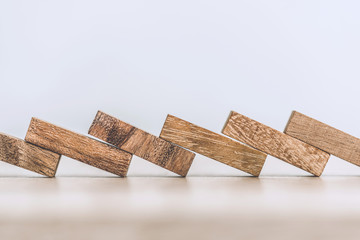 Business loss and folling  concept with block wooden domino effect.