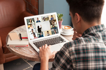 Man use computer laptop with screen of video conference of course online attended by people from many places