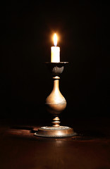 Obraz na płótnie Canvas Lighting Candle On Dark