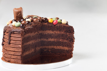 Drip chocolate cakes decorated with colored balls and bars