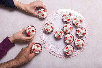 Red velvet cupcake and people hands