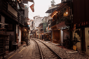 Fototapeta na wymiar Railway in the city through the streets between old houses, Hanoi, Vietnam.