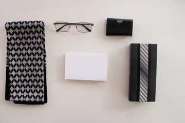 Happy Fathers Day inscription with tie and glases, tool kit or wallet, mens scarf,  on white background white card with the ability to insert text, copyspace, congratulation man, flatlay