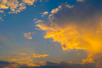 blue sky with golden orange cloud sunset