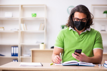 Young man student studying at home in self-isolation concept