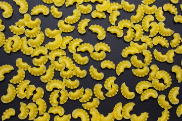 Creste di gallo pasta on black background.