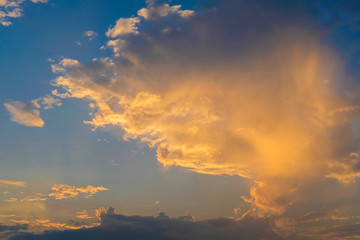 blue sky with golden orange cloud sunset