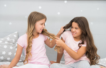 Unhand my hair. Naughty children pull on hair. Beauty look of little girls. Hair salon. Home...