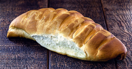 Homemade bread, made from olive oil, on a rustic wooden table. Organic bread, vegetarian diet.