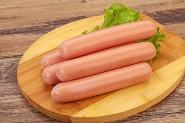 Tasty meat sausages over board