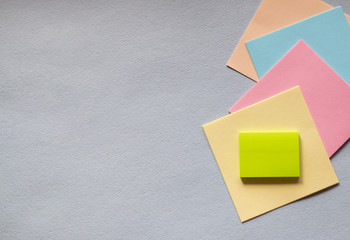 Colored sticky notes on a light background. The view from the top. Space for text. Horizontal photos.