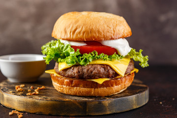 Close-up of home made tasty burger on wooden table.