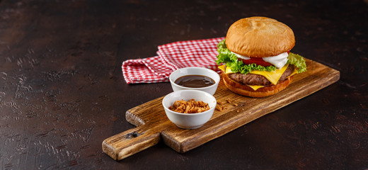 Close-up of home made tasty burger on wooden table.