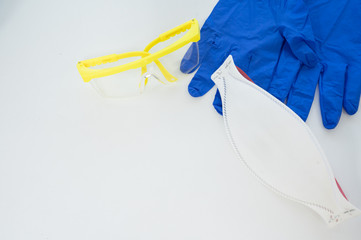 Gloves, face mask, glasses and sugical cap .Different medical protection tool.Personal protective equipment (PPE) for against infection disease.Medical accesory for infectious control concept.