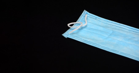 Medical mask on a black background. Respiratory protection against viruses. Epidemics and diseases....