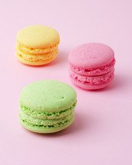 Cake macaron or macaroon colorful almond cookies on a pink background