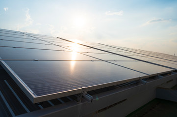 Solar panels and blue sky background.Solar cells farm on the roof.Photovoltaic modules for renewable energy.Save the earth and the energy with good environment concept.