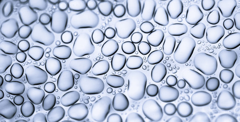 Image from microscopy of water drops in the microscopic slide.Abstract oxygen bubbles in the water.Mixed and different shape background in the black and white tone.