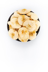 Dried Apples in round bowl on white background, top view