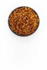 Golden raisins in round bowl on white background, top view